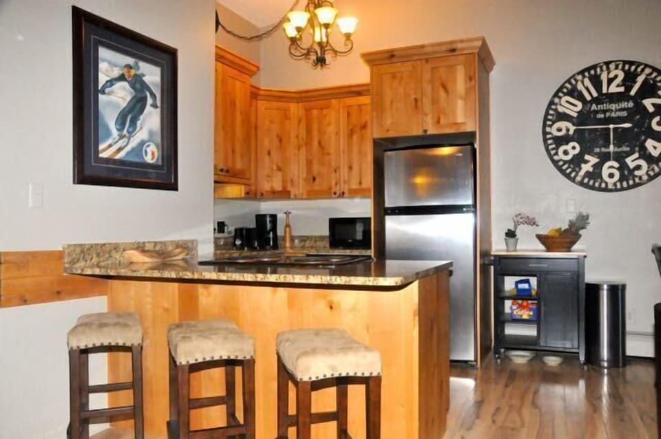Well stocked kitchen with breakfast bar.
