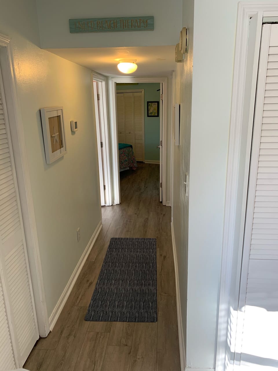 The hallway leads to 2 bedrooms and 2nd full bath