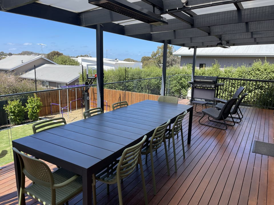 Large deck with large outdoor table and comfortable chairs