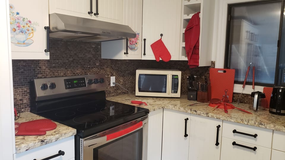 Some of the kitchen's amenities, such as stove and microwave.