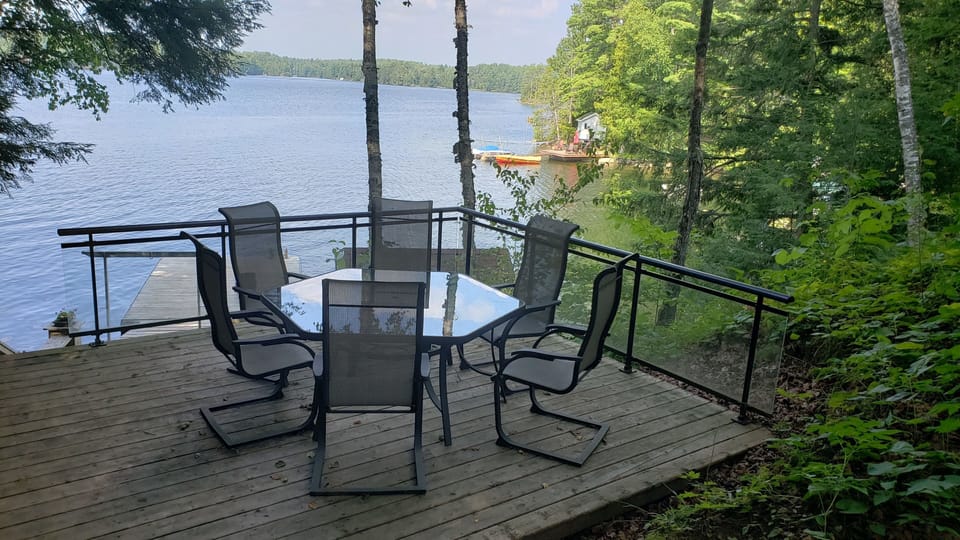 A table with chairs, located near the dock.
