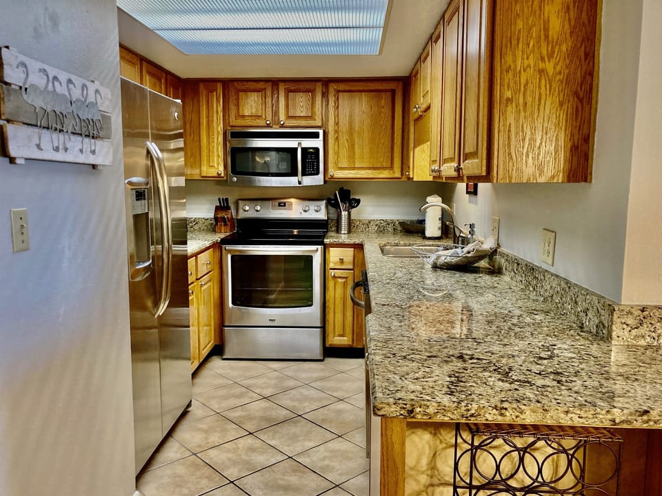The fully stocked kitchen with granite and stainless steel appliances will be perfect for your vacay meals!