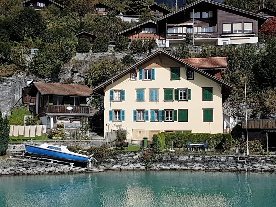 The Boat is to the left of the big house.