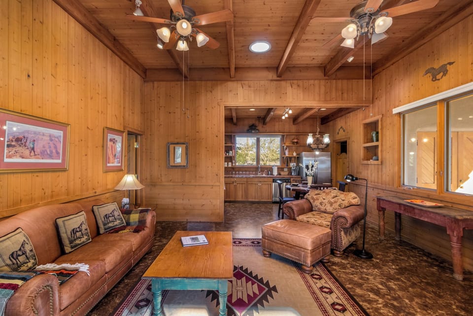Discover the charm of our cozy cabin retreat with a fully-equipped kitchen and adobe fireplace. Unwind in comfort and enjoy a serene escape surrounded by nature.