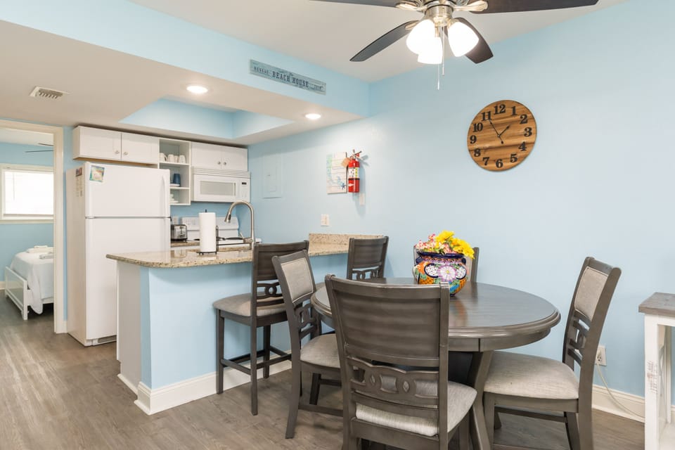 Gather around your spacious dining table while the ceiling fan keeps you comfortable and the open kitchen makes meal prep effortless.