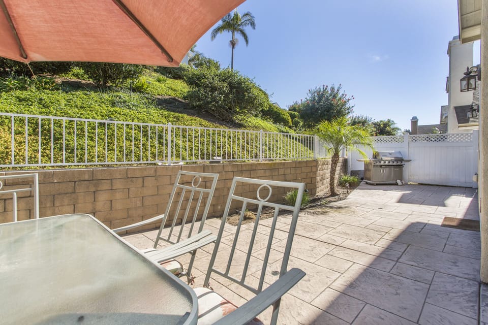 Backyard Stamped Concrete Patio with Table and BBQ