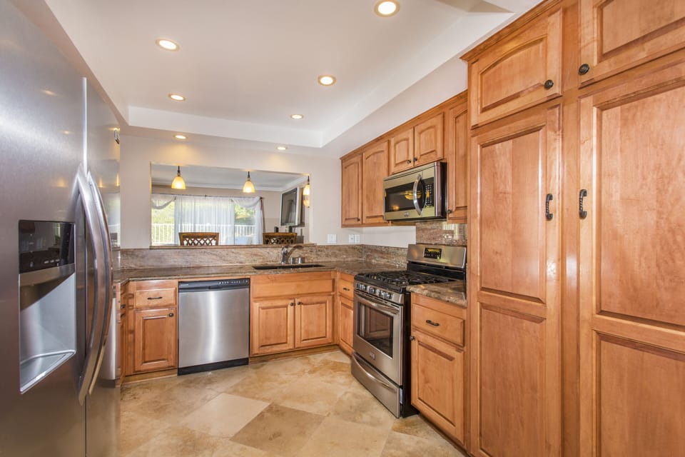 Stainless Steel Appliances, Cherry Cabinets, Granite Counters, Travertine Floors