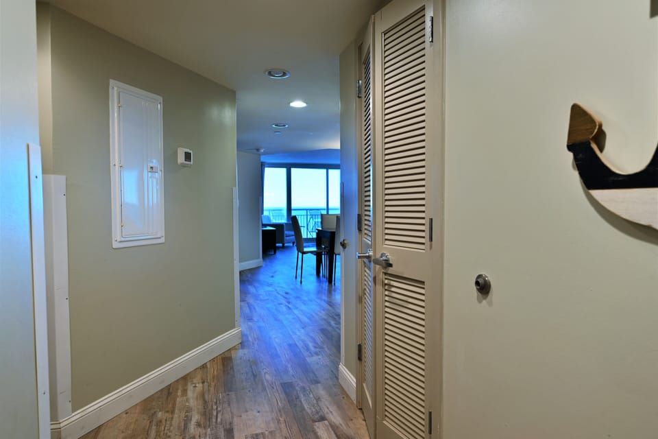 Welcoming entryway to a bright, open living space with distant ocean views.