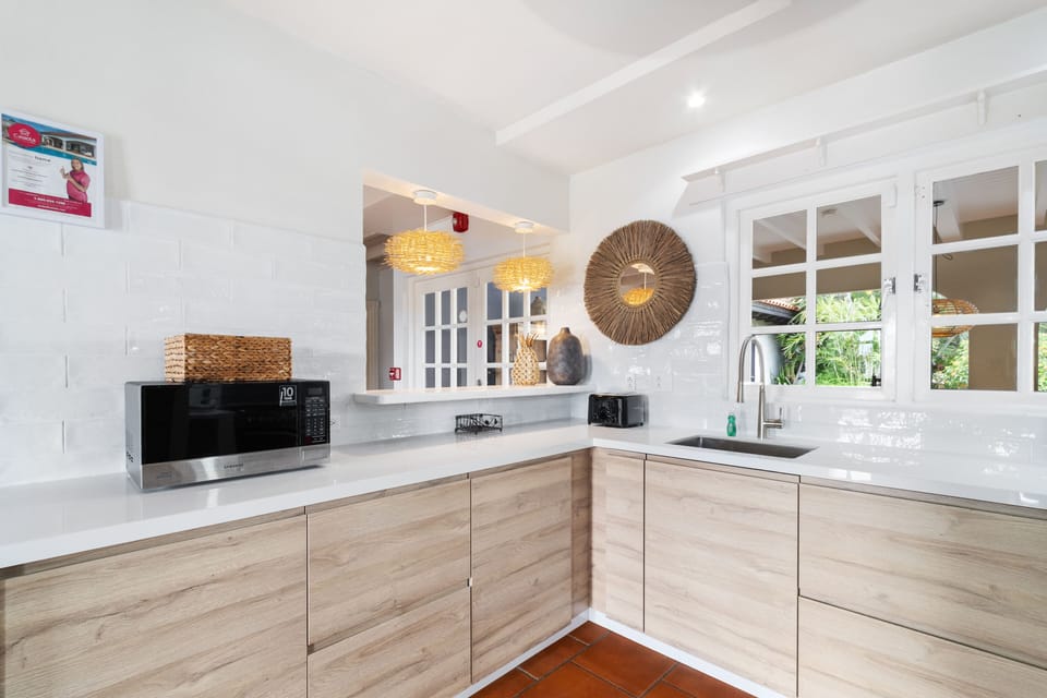Kitchen has a window that overlooks the backyard and pool