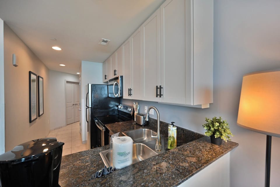 Bright, Functional Kitchen with Beautiful Cabinets and Glass Top Cooking