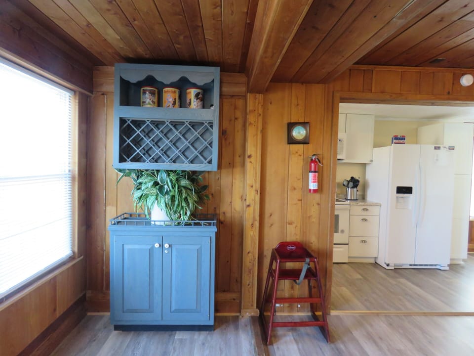 Wine rack, games inside of the cabinet, and a high chair 