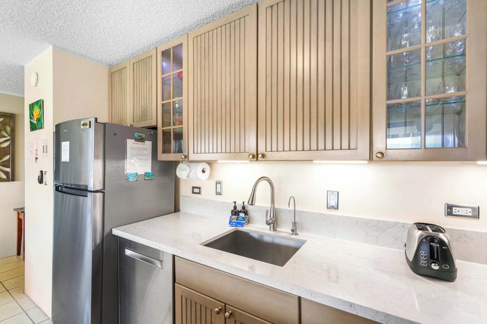 Enjoy the perfect blend of style and function in this sleek kitchen, featuring under-cabinet lighting, ample counter space, and a stainless steel dishwasher