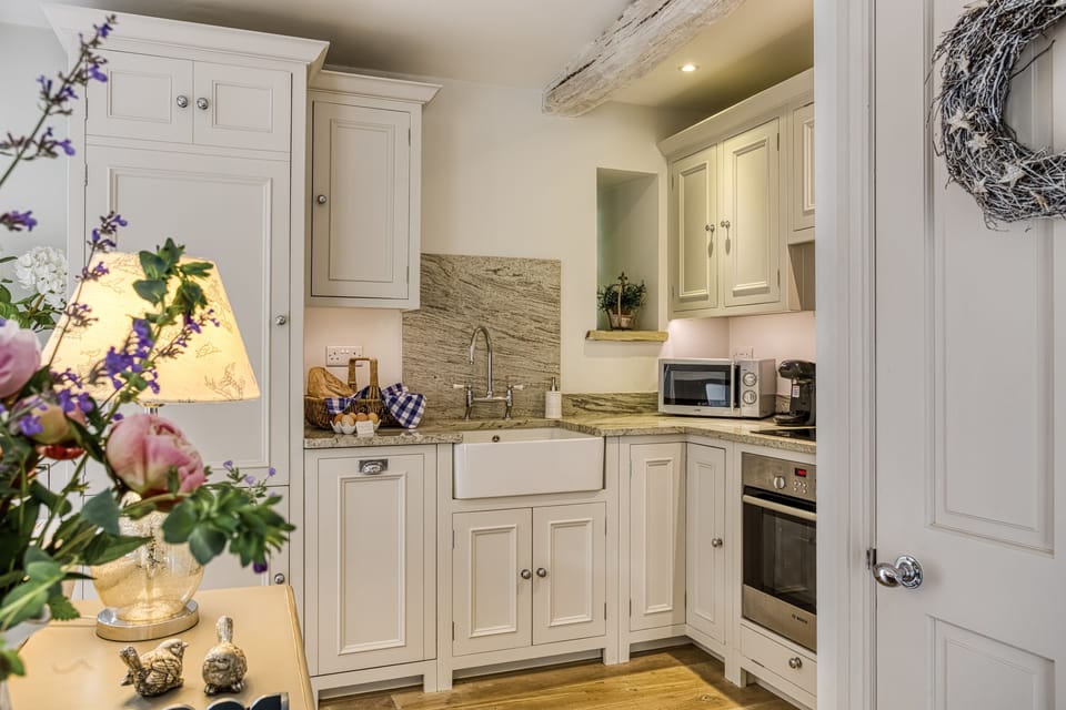 Open-plan New England-style kitchen and living room with limed oak floor and underfloor heating
