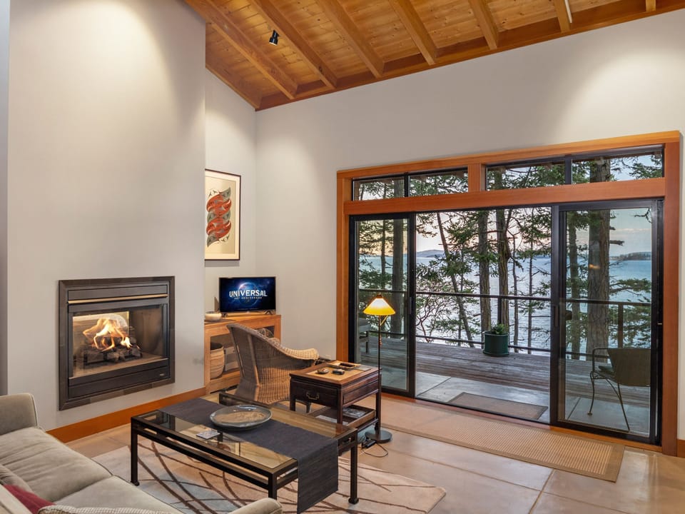 The living room is open and spacious with a propane fireplace and Smart TV