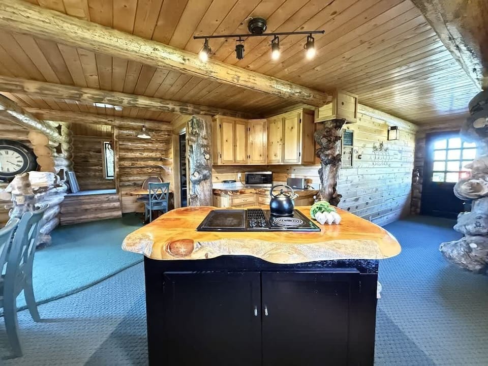 The kitchen in the cabin is a space that feels both functional and comforting, a place where family and friends can gather, cook, and enjoy each other’s company in the heart of the home.