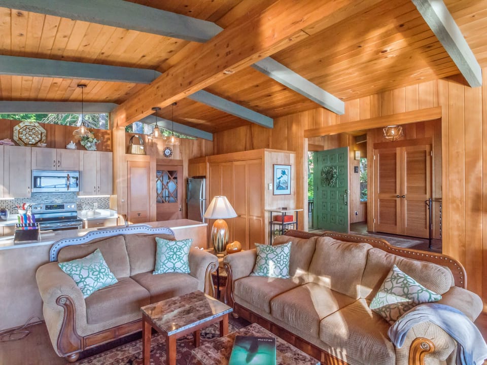 Comfortable living room with kitchen shown behind