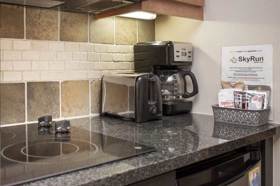 - Start your day with a fresh brew from the drip coffee maker or heat up a quick bite - Modern black toaster and sleek tile backsplash add texture and convenience - Essentials are right at hand in this well organized prep corner