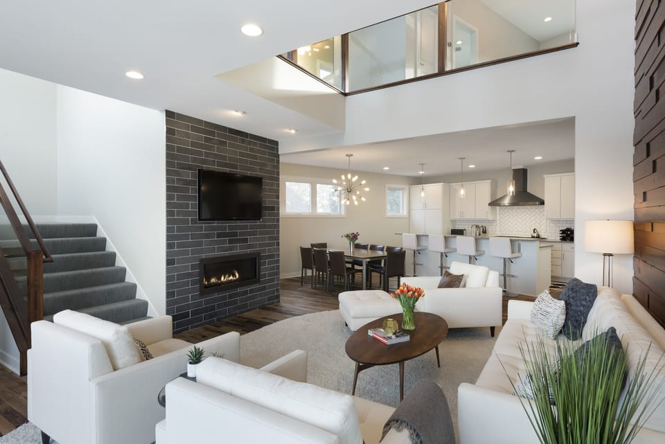 You'll love this stunning open-concept living space with soaring ceilings, modern fireplace, and seamless flow to your fully-equipped kitchen—perfect for relaxing and entertaining.