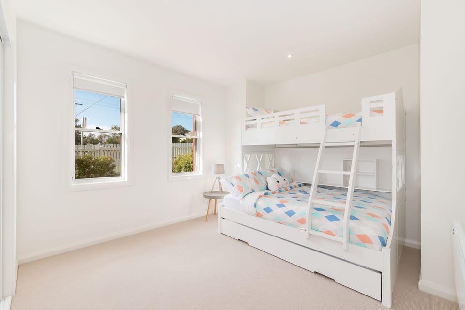 Double bed with top bunk and roll out single bed underneath.
