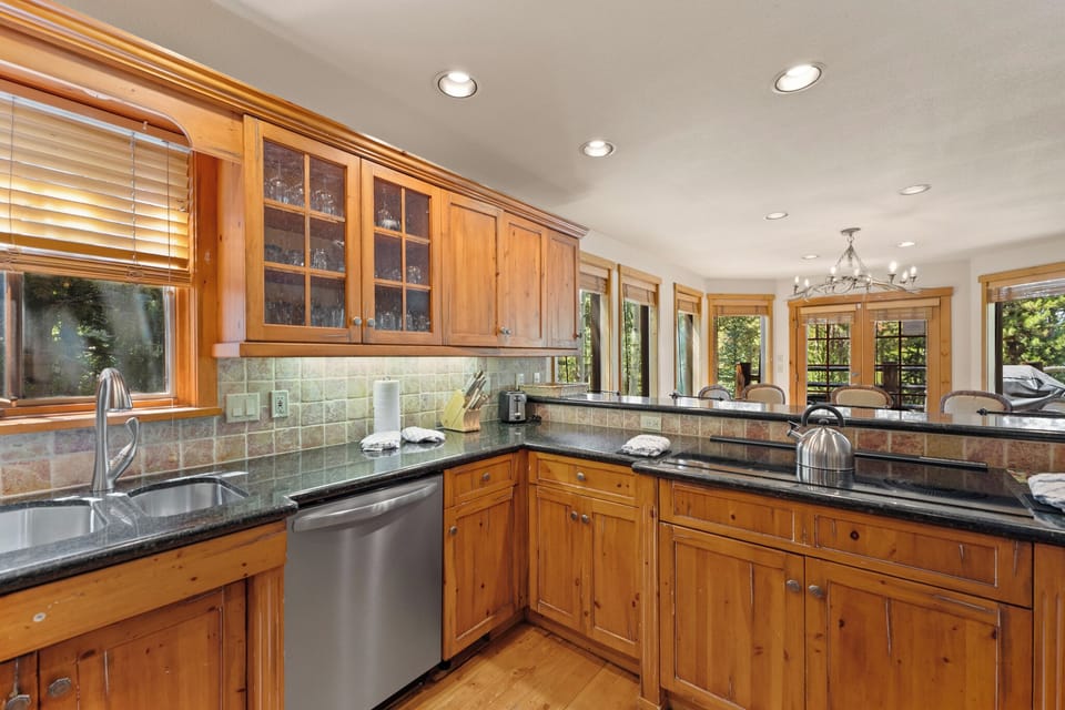 Your spacious kitchen features warm wood cabinetry, granite countertops, and modern stainless appliances perfect for preparing memorable meals.