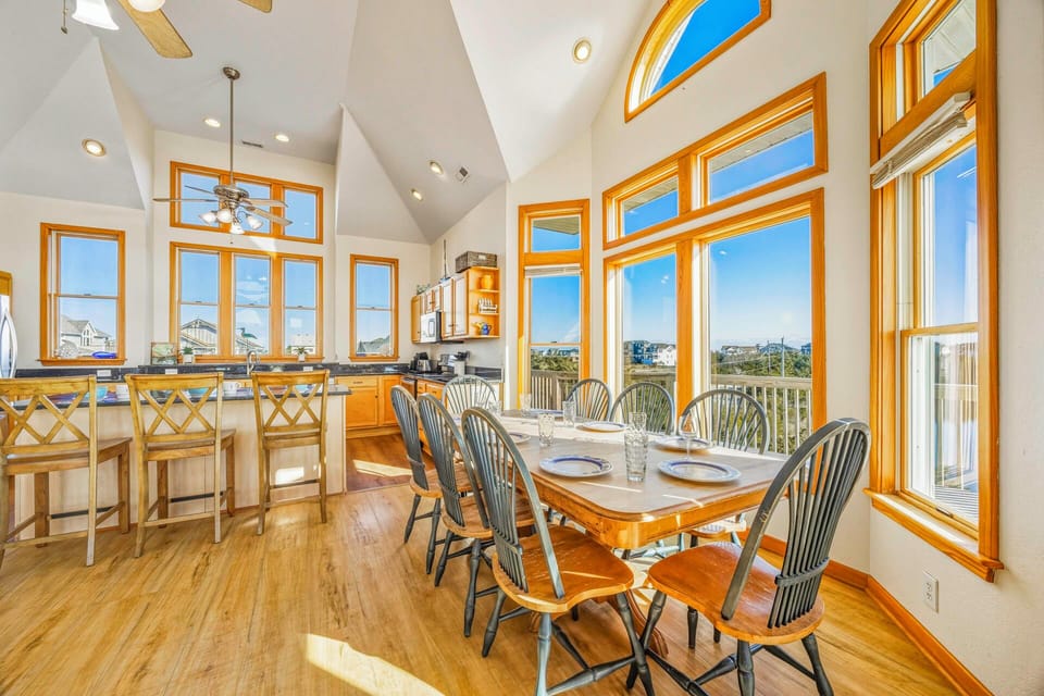 Your spacious dining area flows into a gourmet kitchen, all bathed in natural light from soaring windows that frame stunning views.