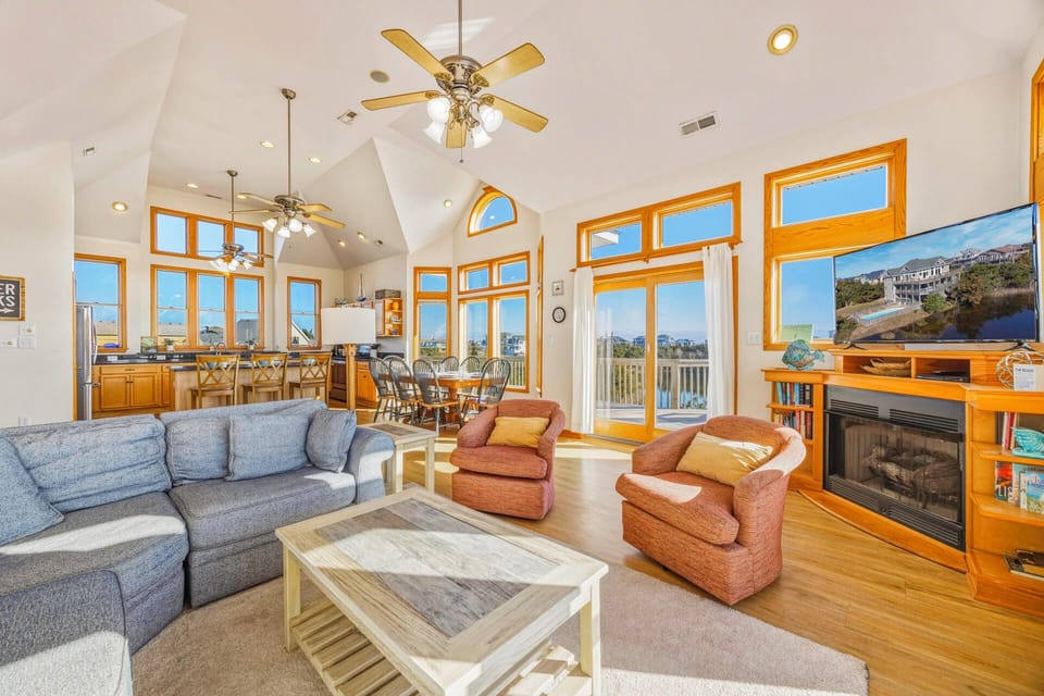 Relax in this bright open living space where soaring ceilings and panoramic windows create an airy retreat for your getaway.