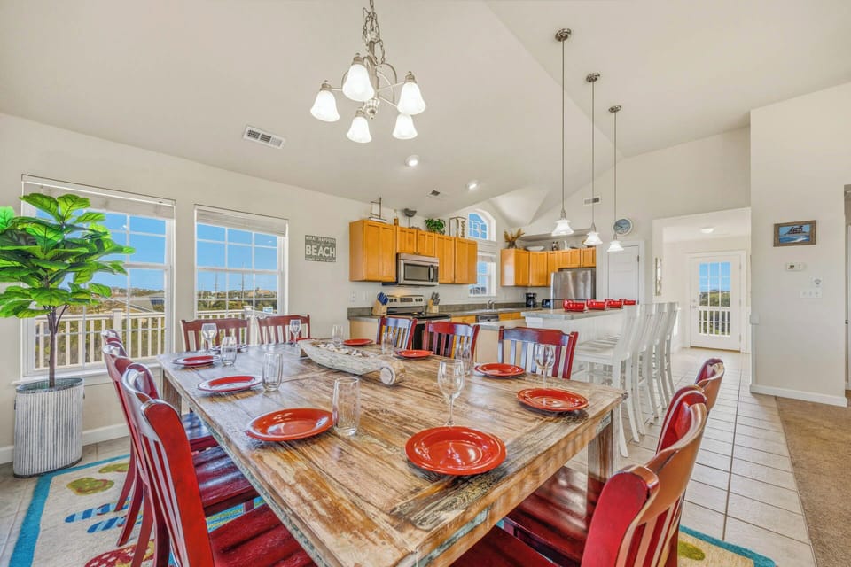 Gather around this rustic dining table where your group can share meals and make memories together. The open kitchen and bright windows create a welcoming space that flows seamlessly into your living area.