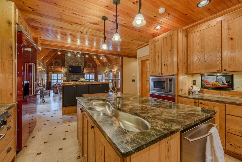 Kitchen has Granite Countertops and Custom Cabinetry