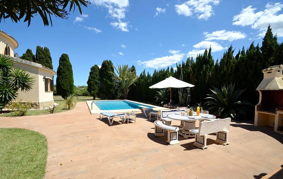 Outside stonetable, benches and sunbeds. with umbrella. Eat and drink here :-)