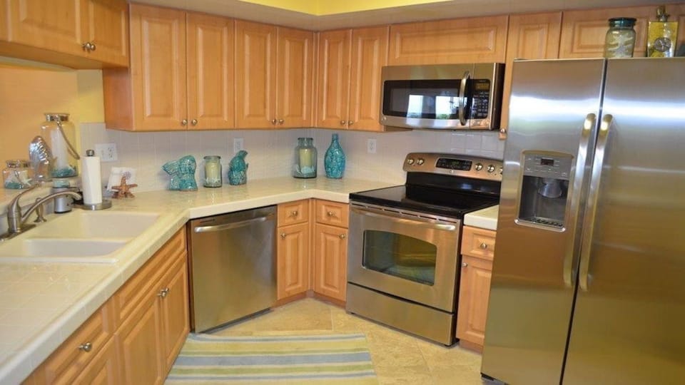 Kitchen with new stainless steel appliances.