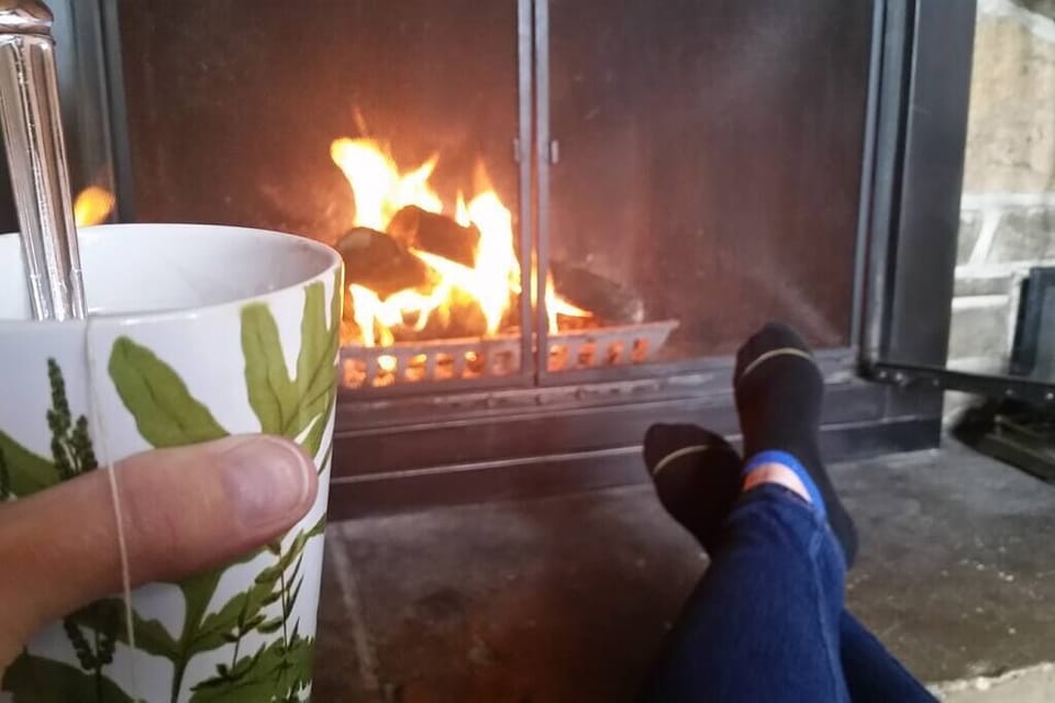 Enjoying some tea by the fire.