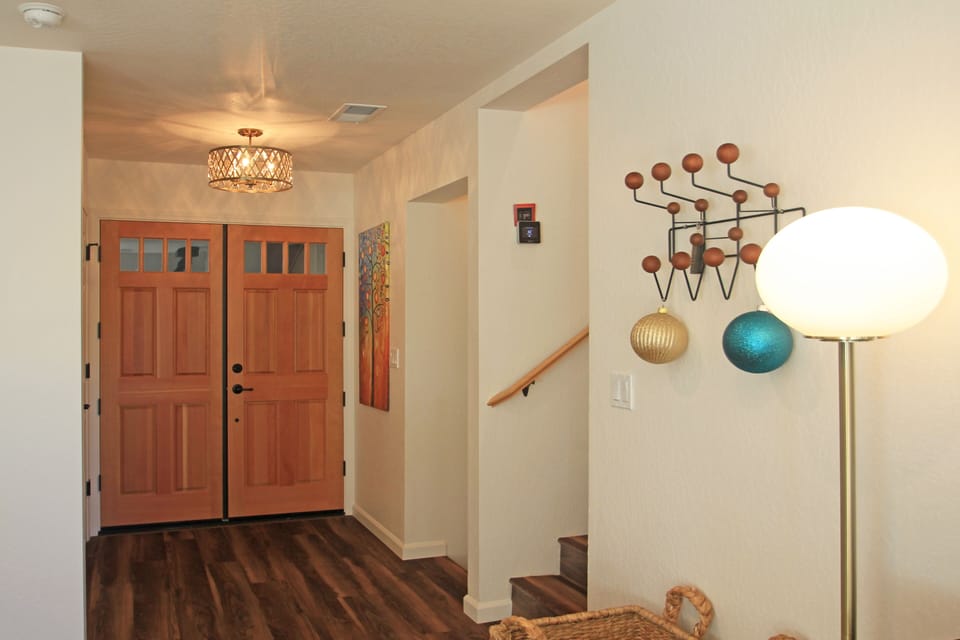To the left of the doors is the second bathroom. Stairs up and down to bedrooms