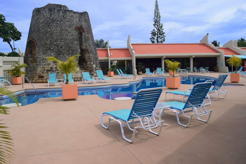 The swimming pool features the remains of a 300 year old sugar mill.