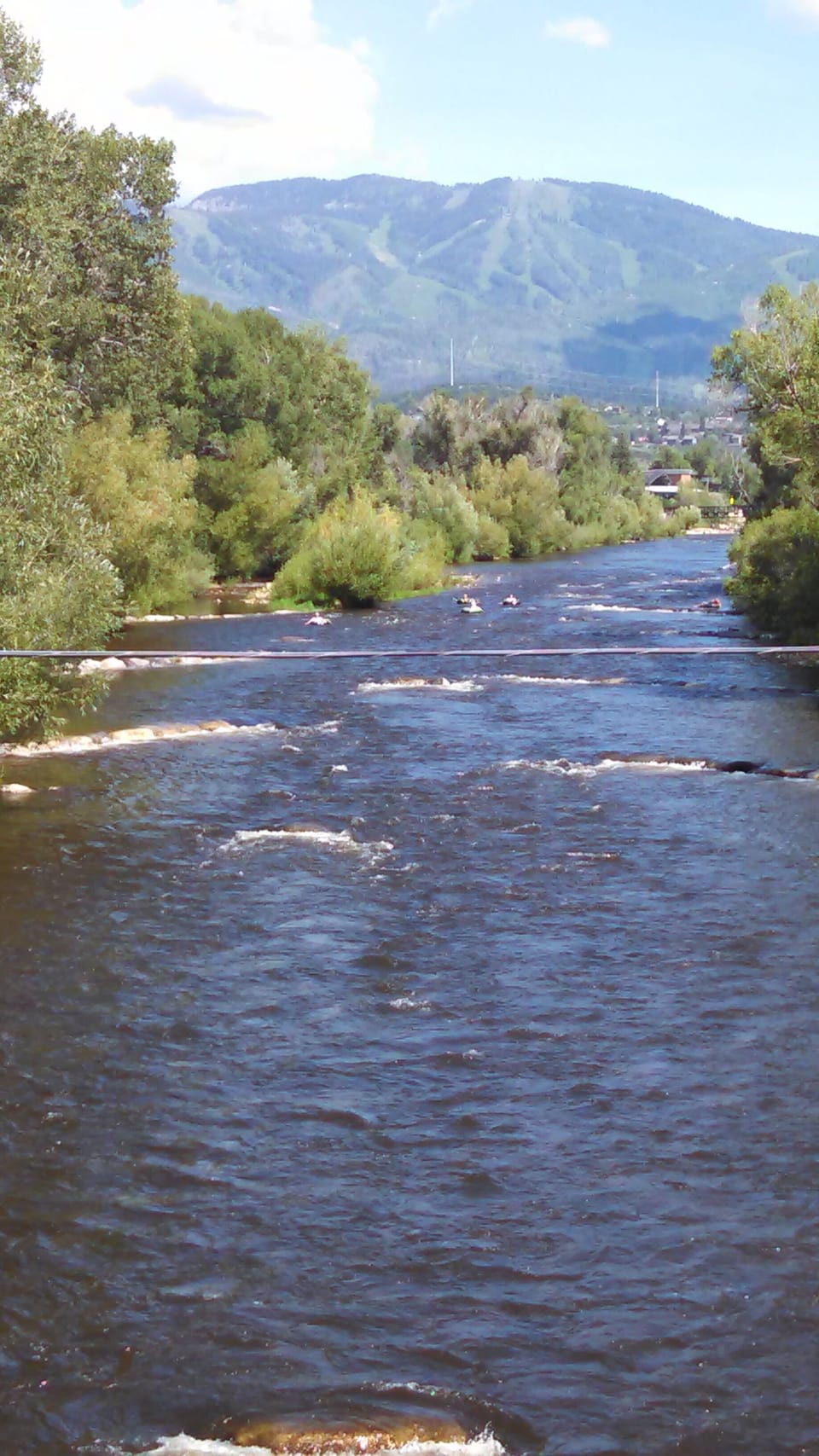 The Yampa River flows through town with the ski mountain in the distance.