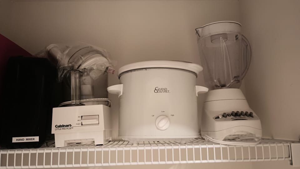 Blender, crock pot, food processor, hand mixer in the pantry.