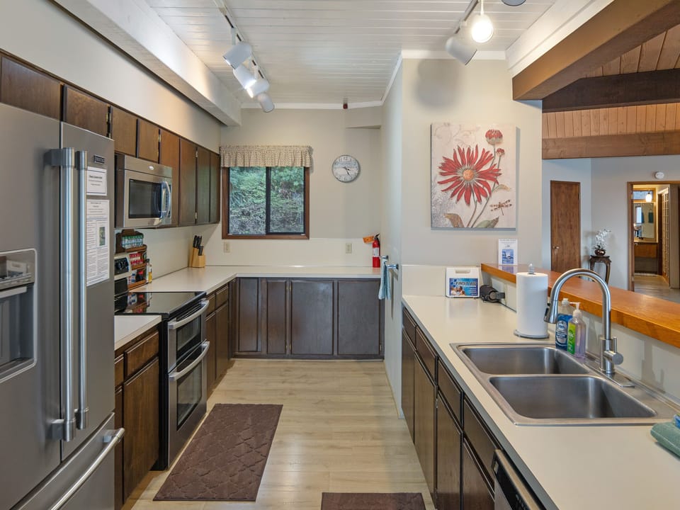 Full kitchen with views of the water and open living area.