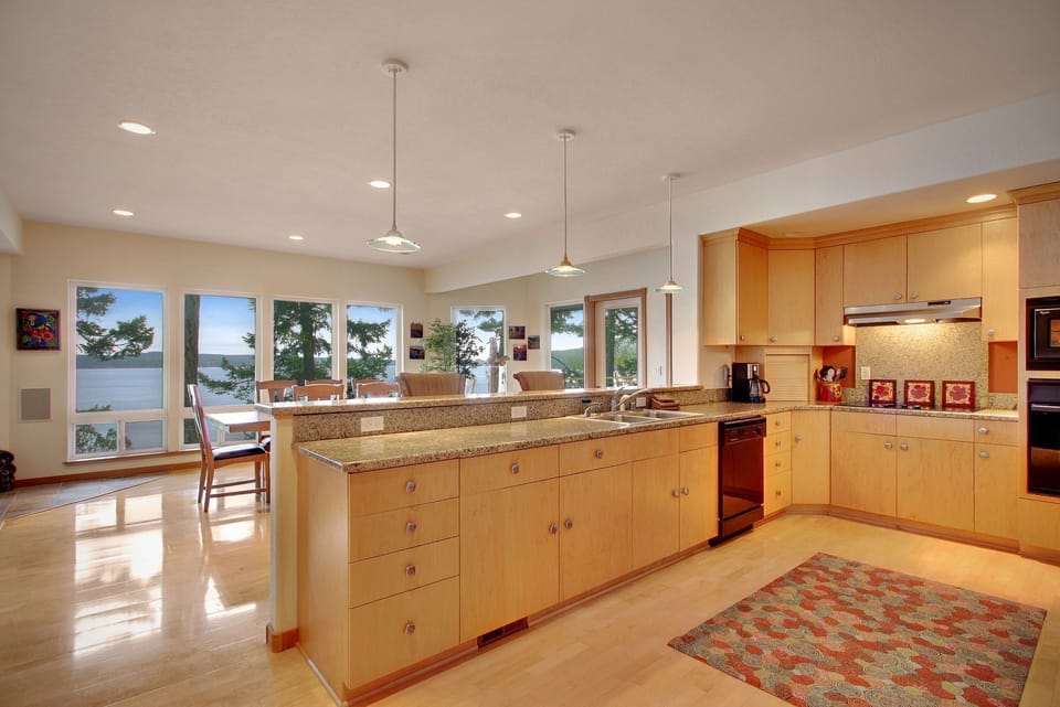 Fully equipped kitchen is open to the dining area.