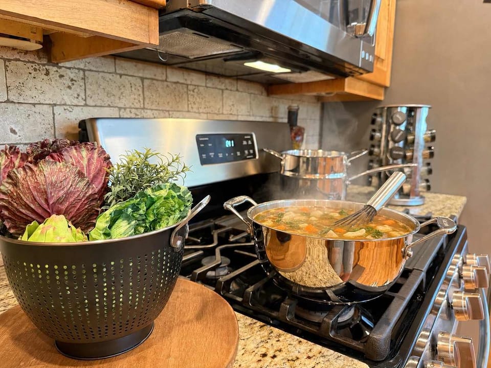 gas range with spices, pots and pans, utensils and small appliances.