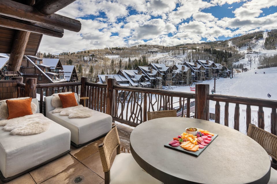 Savor mountain mornings on your private balcony with ski-in views and cozy seating for the perfect alpine breakfast.