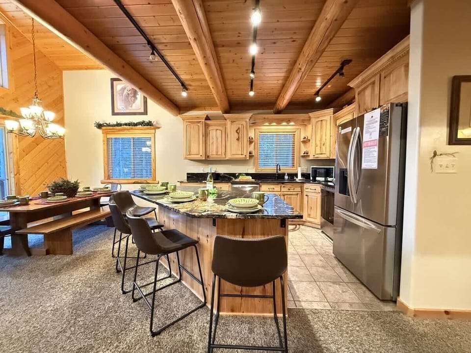 The open kitchen blends seamlessly into the cabin's cozy living area, creating a welcoming space perfect for gathering and unwinding.