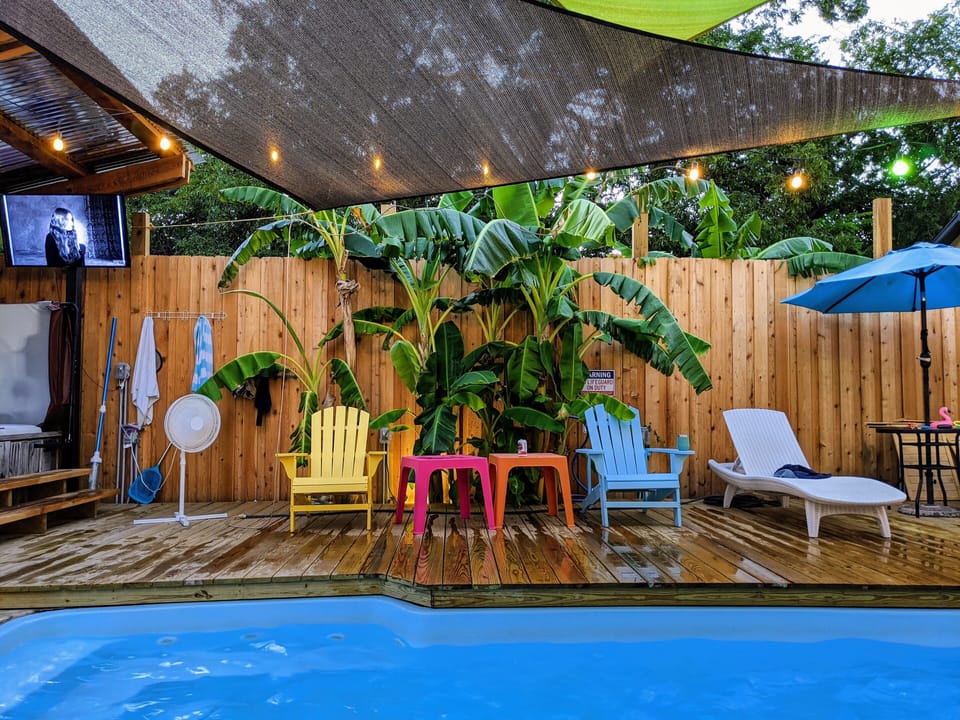Pool and backyard oasis with covered hot tub