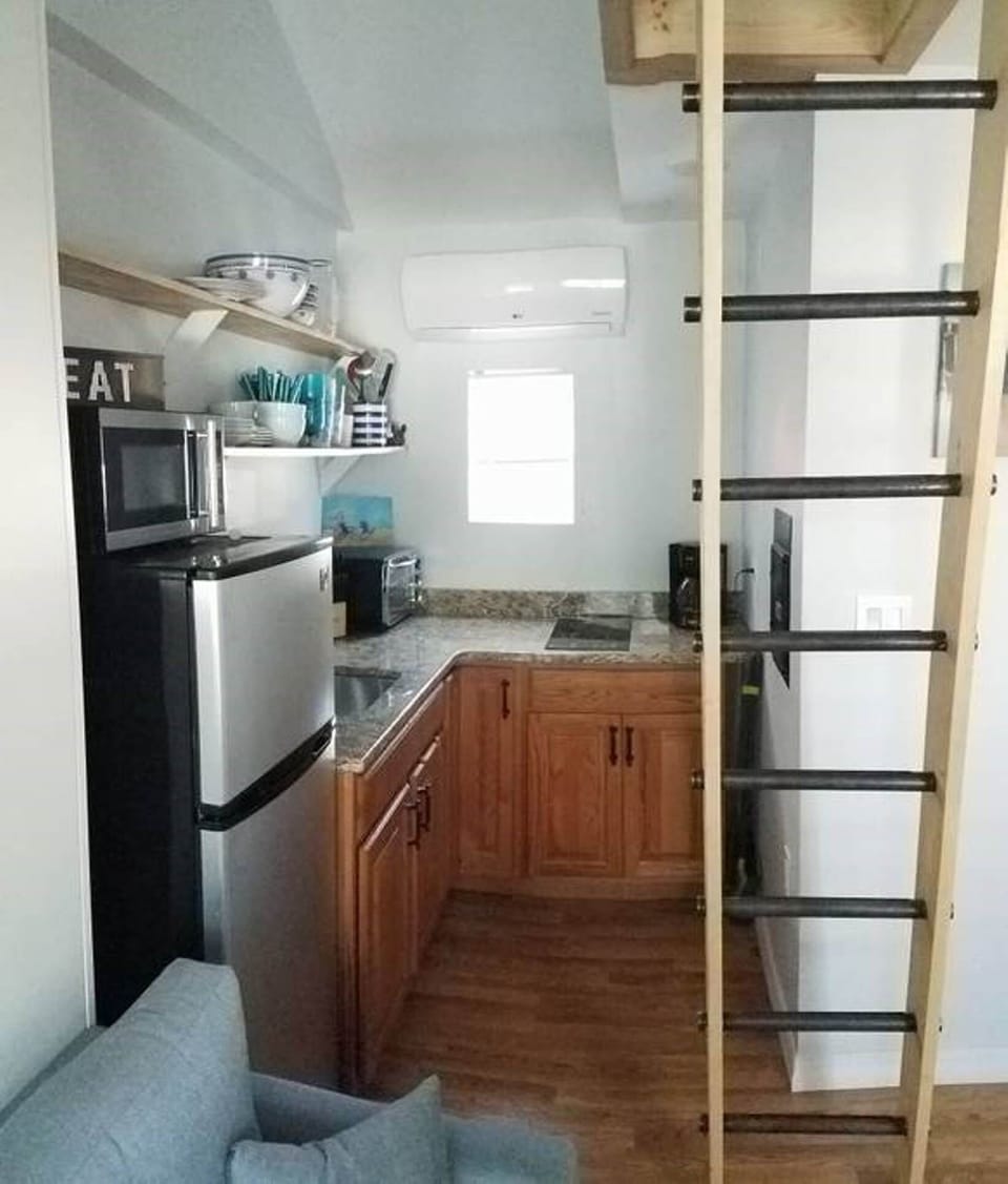 Kitchen with cook top, fridge, sink, and toaster oven. Modern HVAC. 