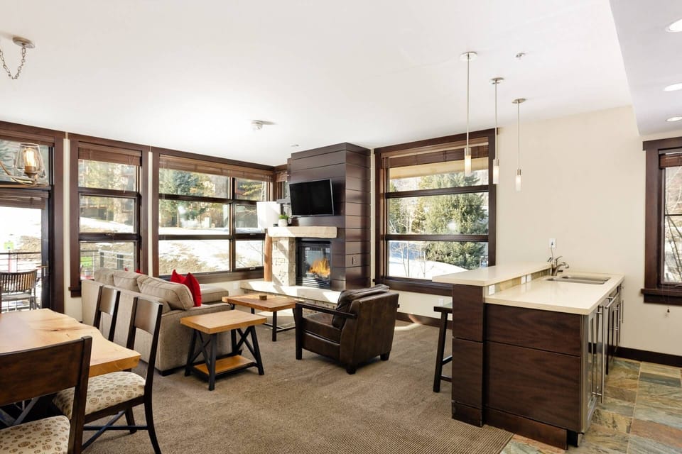 Relax by the fire and enjoy the view of the skiers on the mountain!