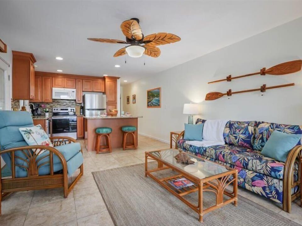 Tropical Open-Concept Living - Open-concept living area with tropical furnishings, a full kitchen, and comfortable seating—perfect for relaxing after a day on teh Kona Coast