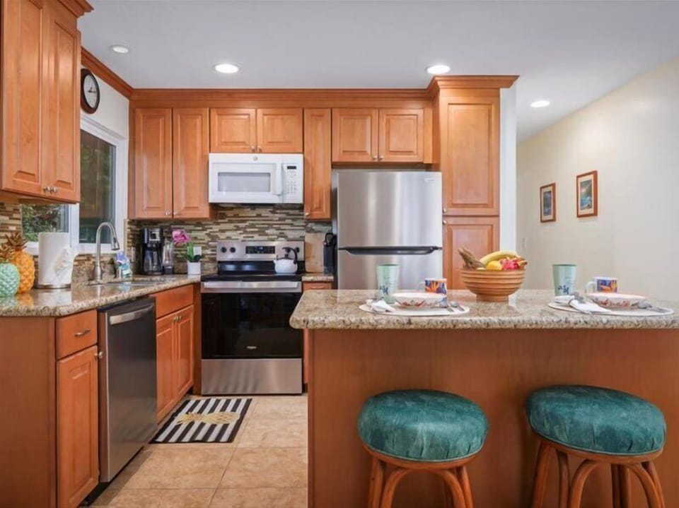 Enjoy cooking and dining in this beautifully updated kitchen wit - Updated kitchen with stainless steel appliances, granite countertops, and a breakfast bar perfect for casual dining.