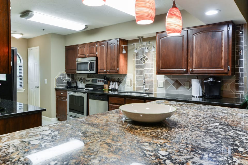 Large Fully stocked Kitchen, granite counters, stainless appliances.