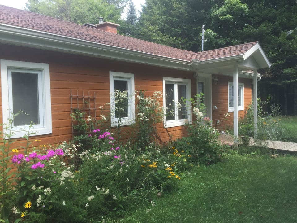 Front of house with beautiful gardens