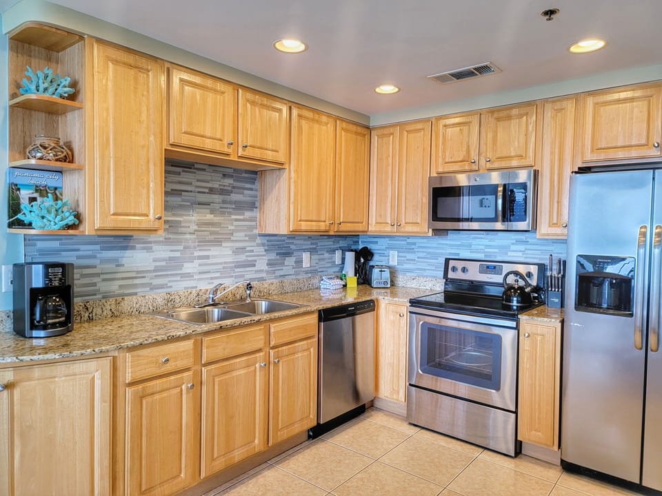 Fully equipped kitchen with stainless steel appliances and granite countertops