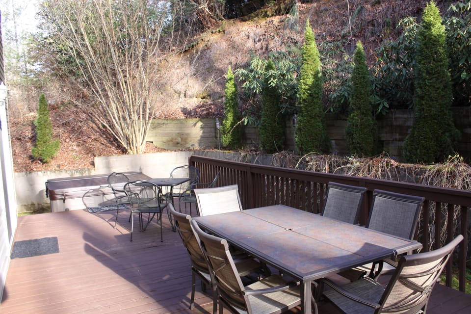 Deck with grill, hot tub and seating for 10 and umbrellas in the summer