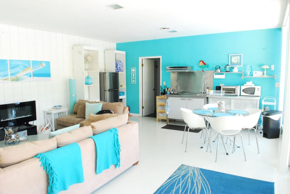 Newer photo Living room reverse angle at efficiency kitchen